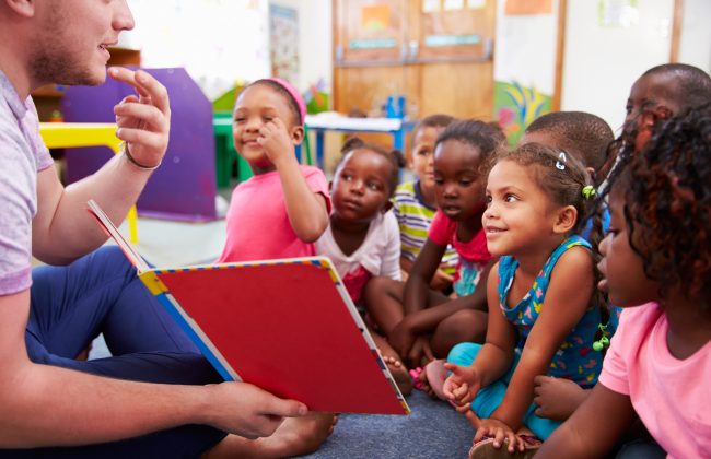 Volunteer Teacher Reading to a Class of Preschool Kids